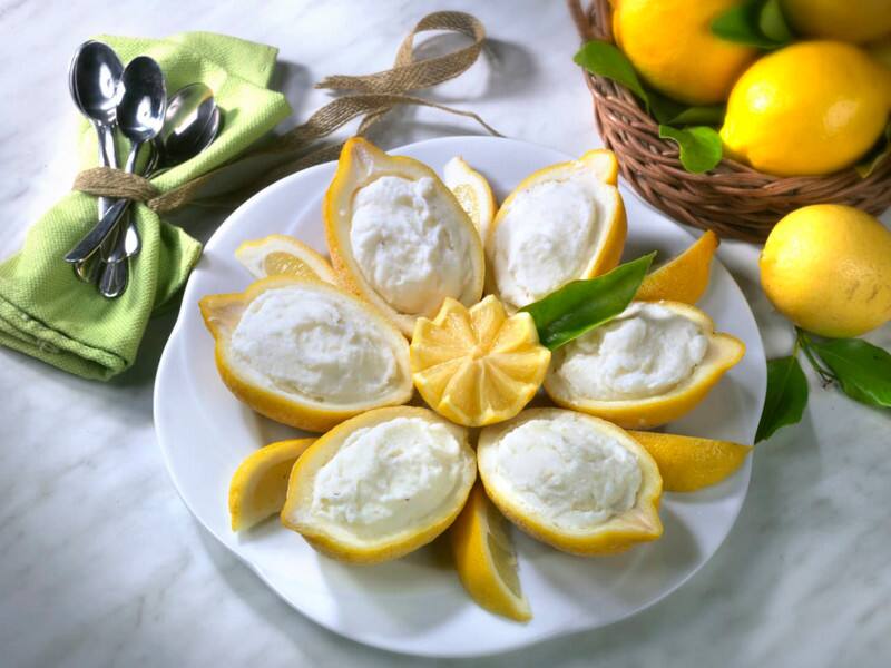 Lemon sorbet served in its own peel, and the villa's private chef at work with a sea-view table.