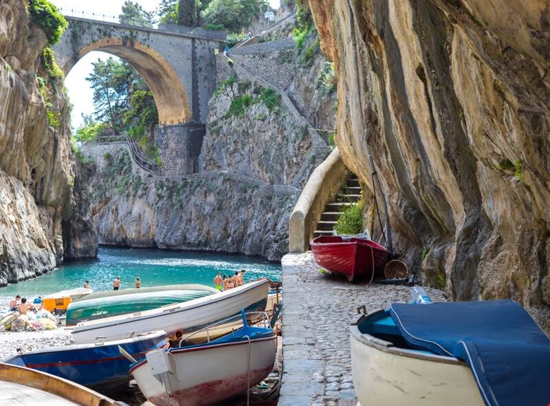The fjord, its bridge and the boats drawn up on the stone quay.