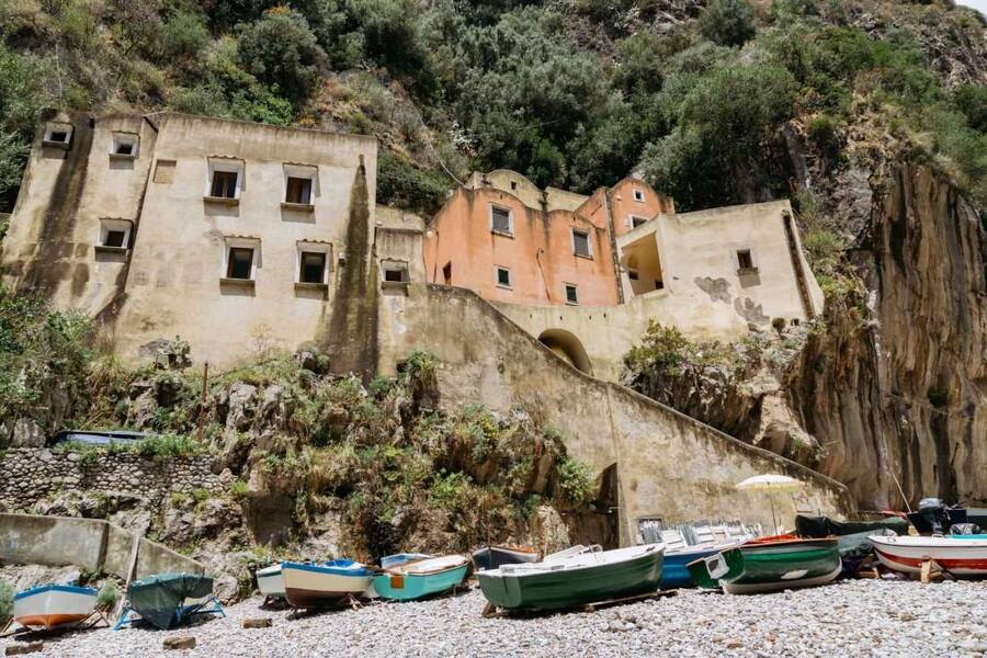 The monazzeni above the pebble beach, the old stone shelters of the fishermen.